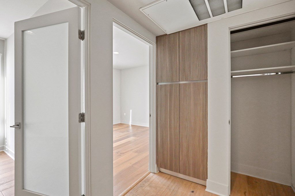 Hallway with Coat Closet and Built-In Cabinet Storage