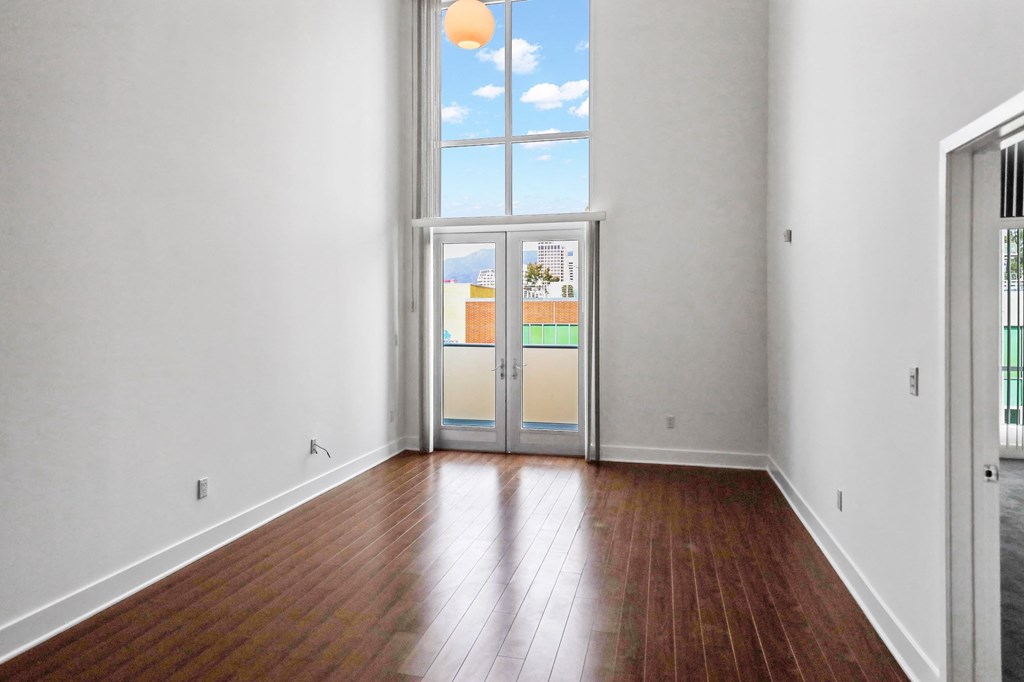 Living Room Space with Vinyl Flooring and Floor to Ceiling Windows