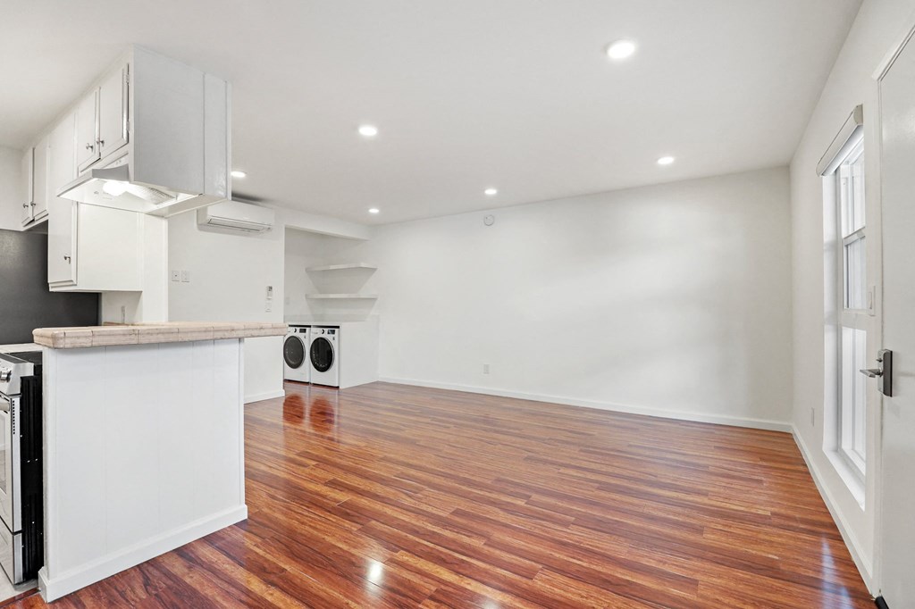 Kitchen, Dining, and Living Room Space with Recessed Lighting, Vinyl Flooring, and Large Windows