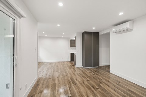 Living Room Area with Vinyl Flooring, Wall Heater, and Patio Entrance