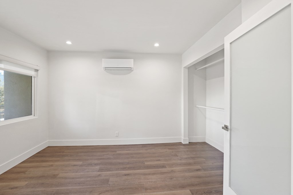 Bedroom with Wall Heater and Closet