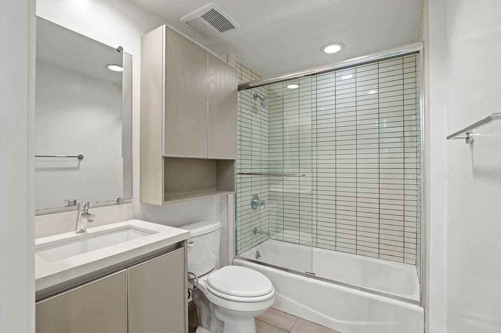 Bathroom with Full-Size Bathtub and Cabinet Storage