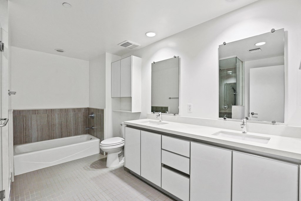Large Bathroom with Full-Size Bathtub , a Double-Sink Vanity, and Cabinet Storage