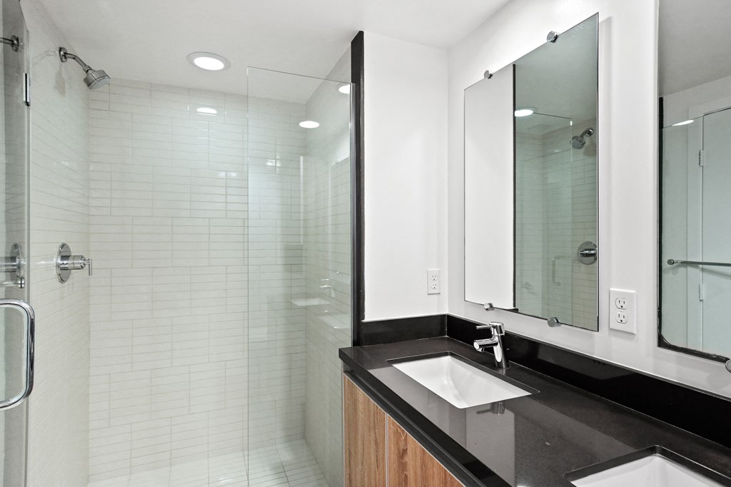 Bathroom with Double Sinks and Full-Size Walk-In Shower