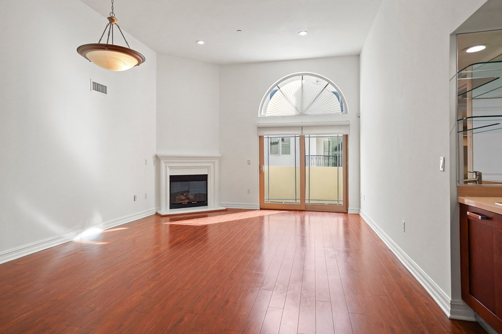 Living Room Space with a Wet Bar, Fireplace, and Balcony