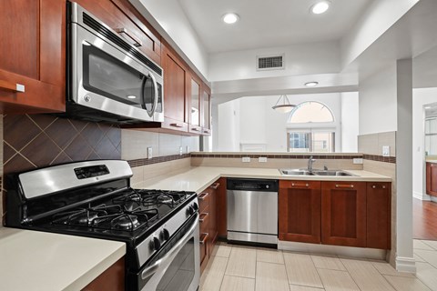 a kitchen with a stove and a microwave and a sink