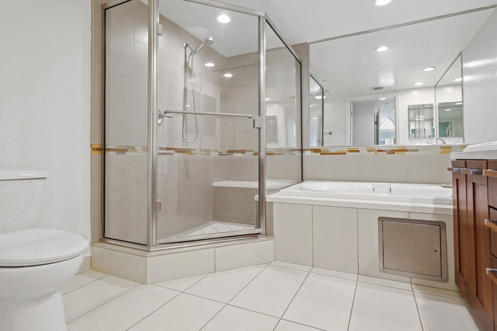 Spacious Master Bathroom with Bathtub and a Walk-In Shower