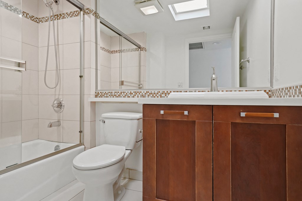 Bathroom with Full-Size Bathtub and Cabinet Storage