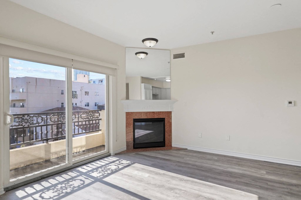 Bright Living Room Space with an Electric Fireplace and Private Balcony