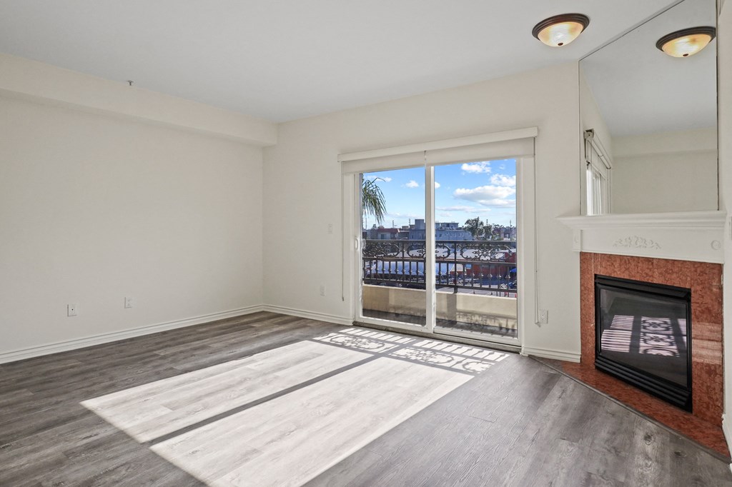 Large-Size Living Room Area with an Electric Fireplace and a Private Balcony