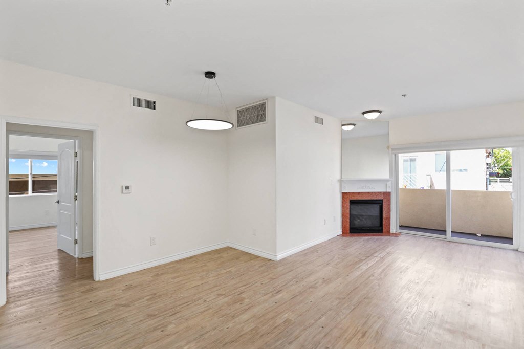 Open-Concept Dining and Living Room with Electric Fireplace and Private Balcony