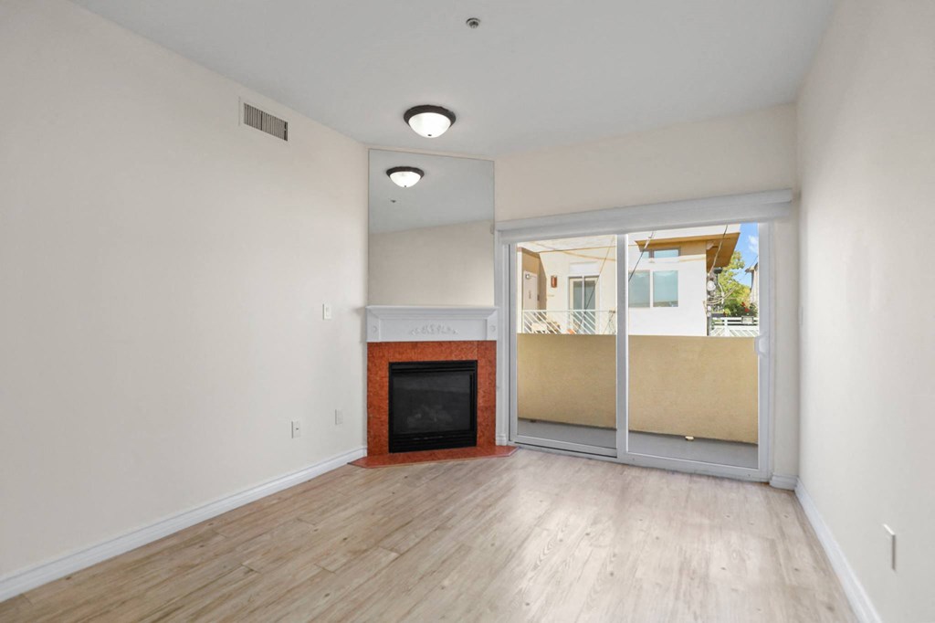 Living Room Space with Electric Fireplace and Private Balcony