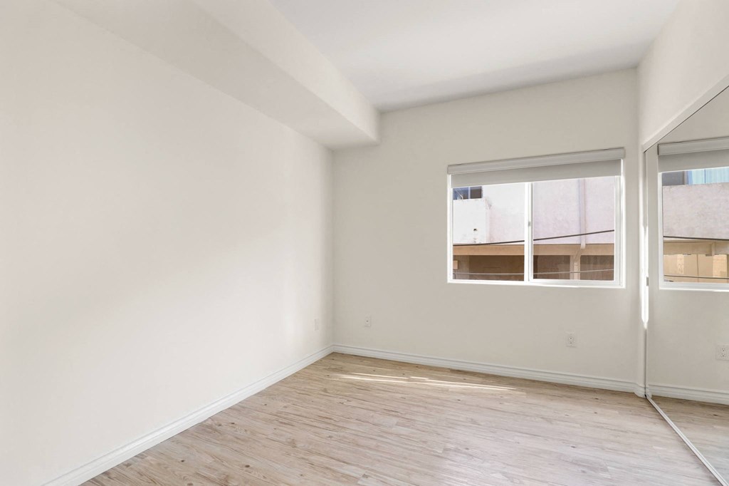 Bedroom with Mirrored Closet and Window