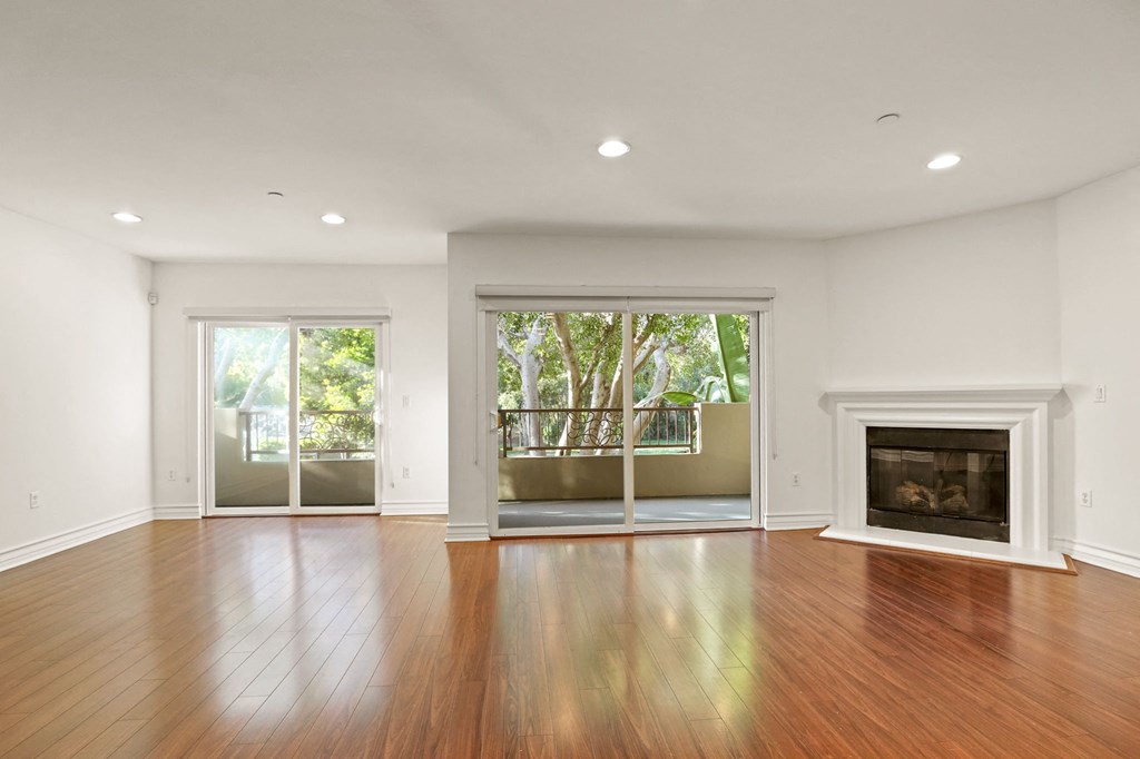 Spacious Living Room Area with an Electric Fireplace and Patio