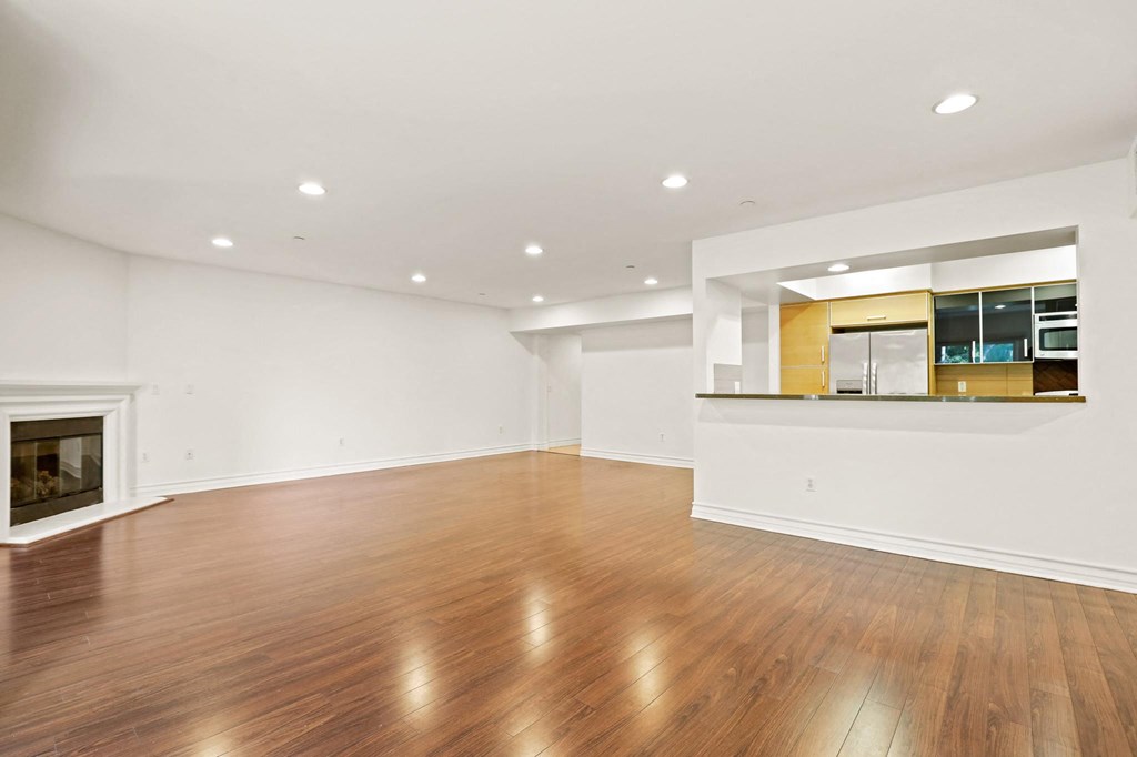 Living Room Area with an Electric Fireplace and Vinyl Flooring