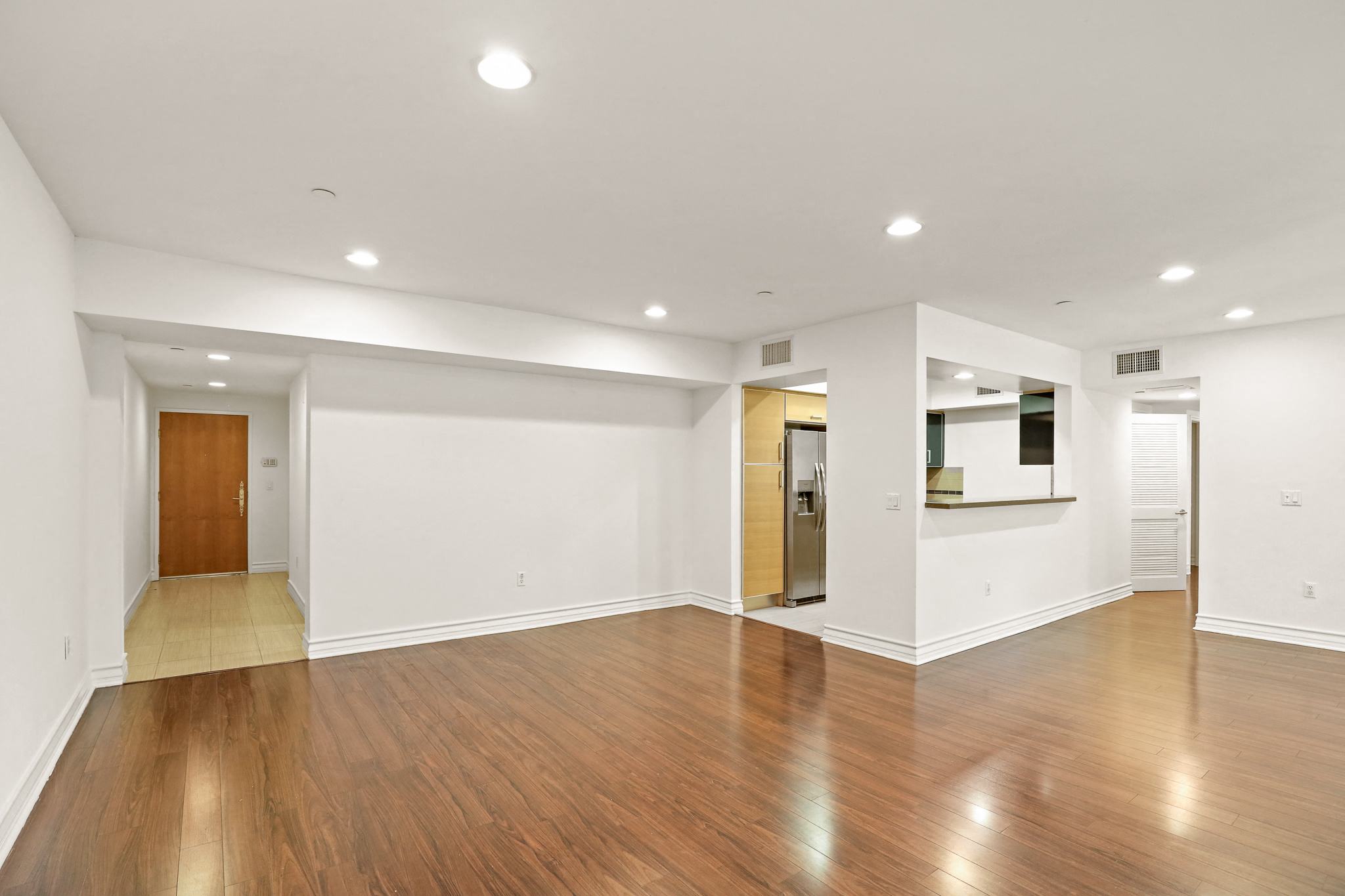 Spacious Living Room with Vinyl Flooring and Recess Lighting