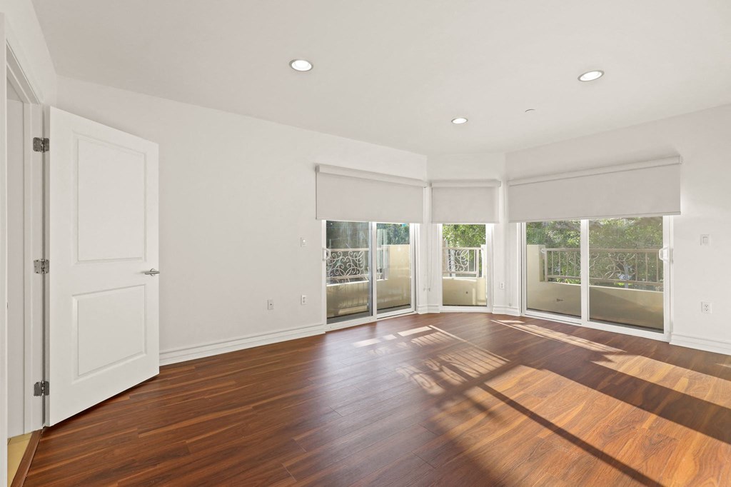 Spacious Size Bedroom with Hardwood Flooring and Large Windows