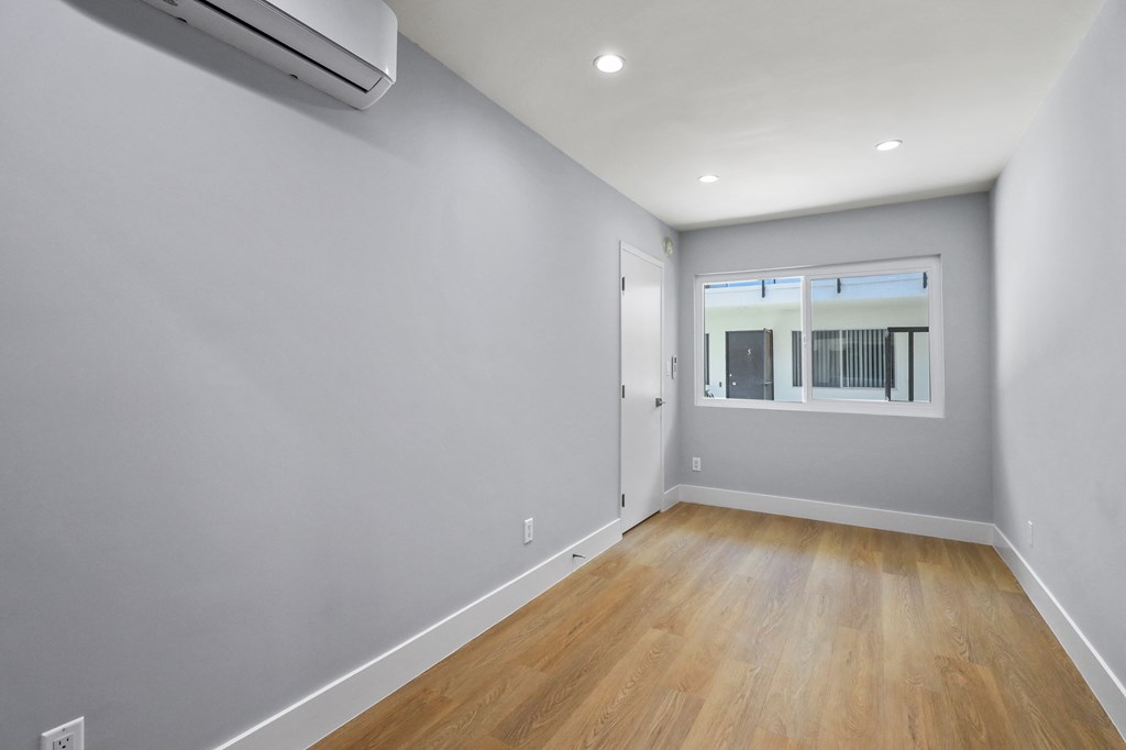 Bedroom with Large Windows, Vinyl Flooring, and Recessed Lighting