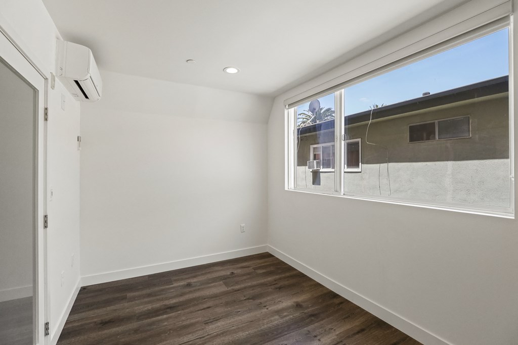 Bedroom with a Full-Size Closet and Large Window