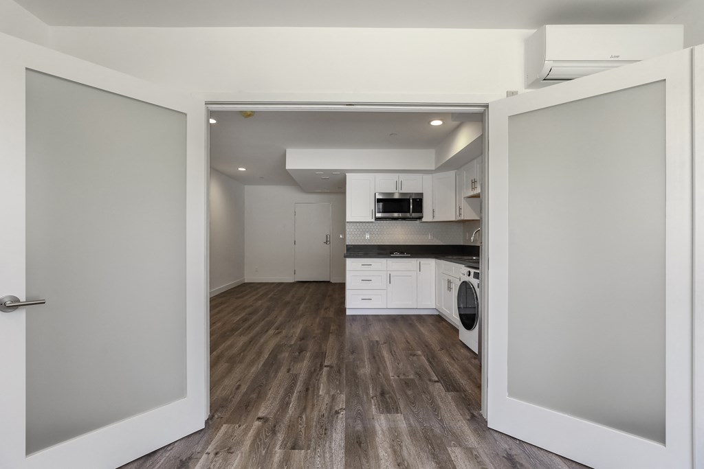 Apartment Home Featuring Vinyl Wood Flooring, Stainless Steel Appliances, and Recess Lighting