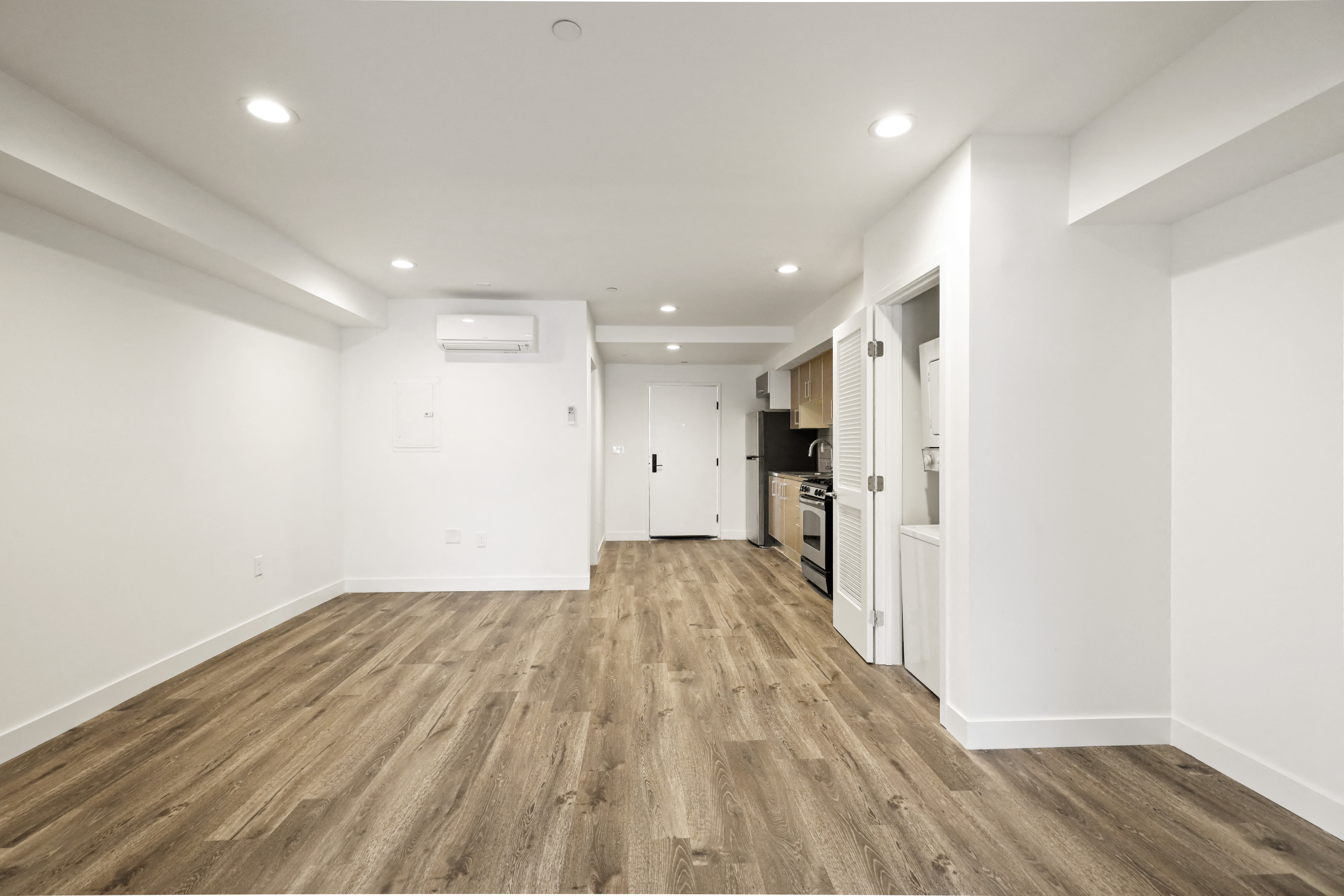 Open-Concept Dining and Living Room Space with Washer and Dryer