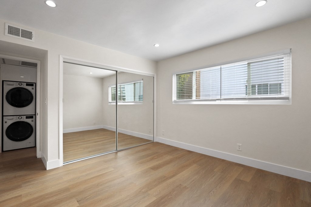 Bedroom with Large Mirrored Closet and Window
