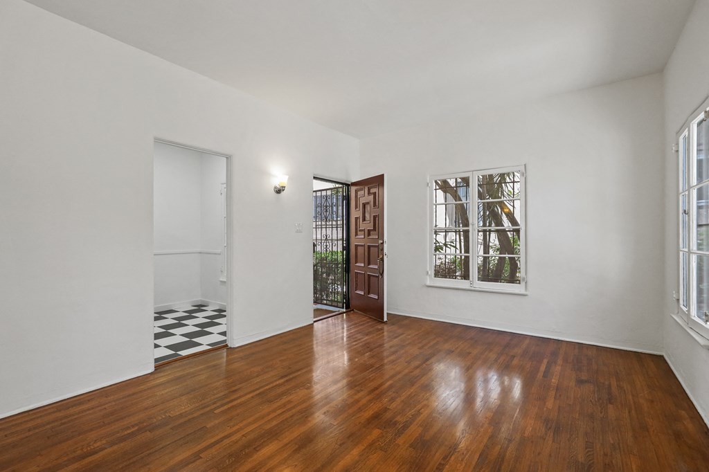 Front Door Entrance into Living Room Area with Hardwood Floors