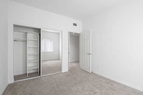 Bedroom with Closet with Built-In Shelving