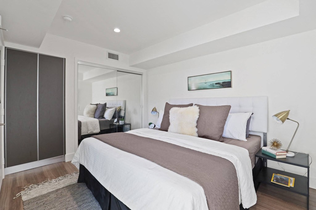 Bedrooms with Large Mirrored Closet Space and Additional Cabinet Storage