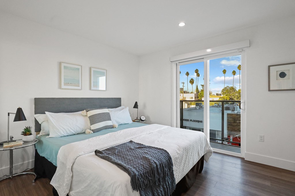 Spacious Bedrooms with Vinyl Flooring, Recessed Lighting, and Balcony Access