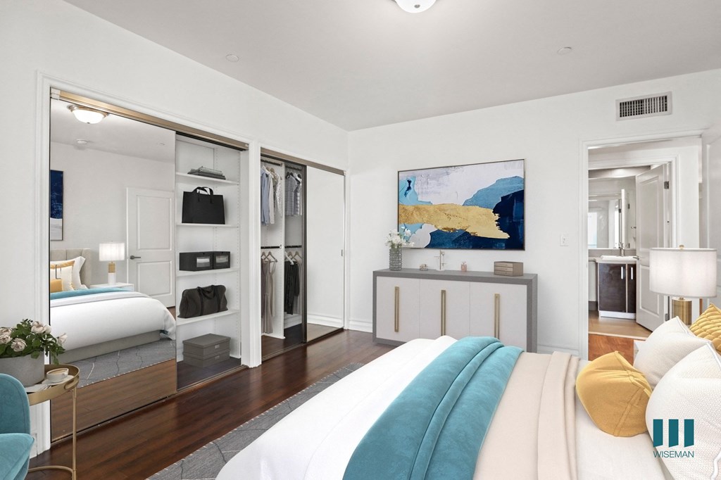 Bedroom with Two-Mirrored Closets, Vinyl Flooring, and Bathroom