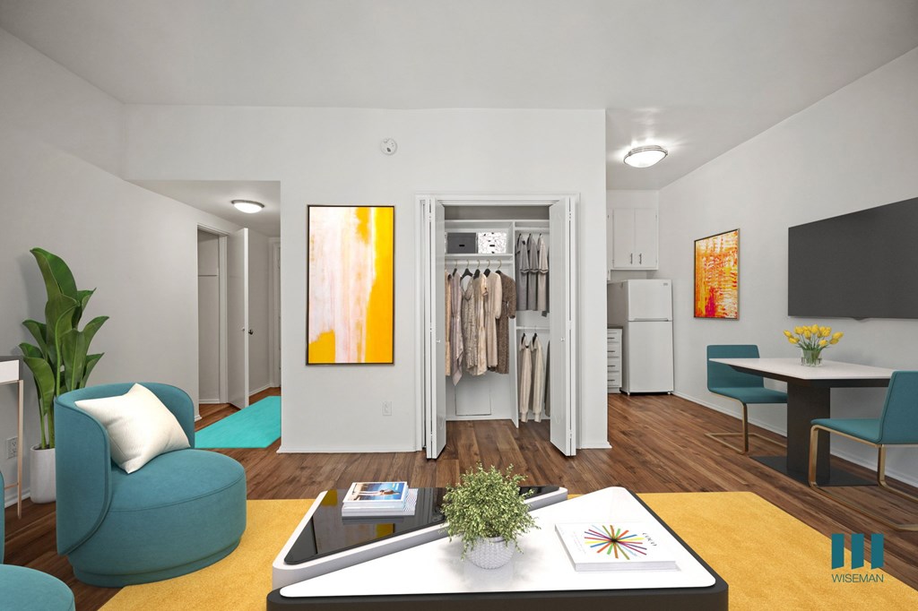 A modern living room with a blue chair, a coffee table, and a painting on the wall.