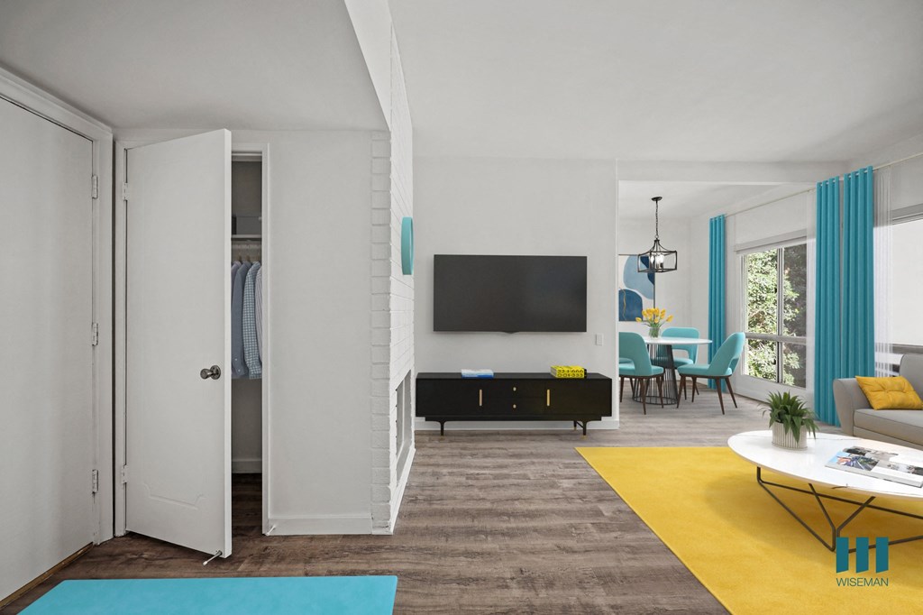 A modern living room with a television, a sofa, a coffee table, and a dining table.