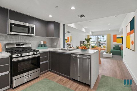 A modern kitchen with a stainless steel oven and microwave.