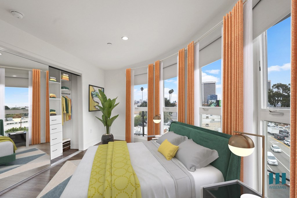 Modern Bedroom with Lots of Windows Providing Natural Light and a Mirrored Closet with Built-In Organizers