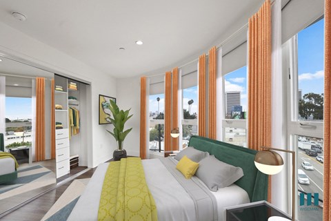Modern Bedroom with Lots of Windows Providing Natural Light and a Mirrored Closet with Built-In Organizers
