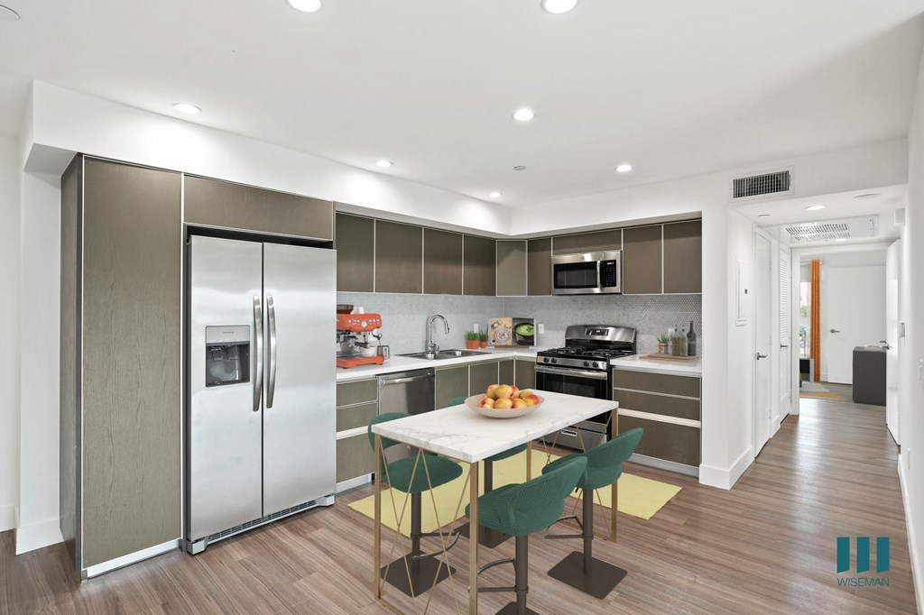 Open-Concept Kitchen with Staineless-Steel Refrigerator, Stove, Microwave Oven, and Dishwasher