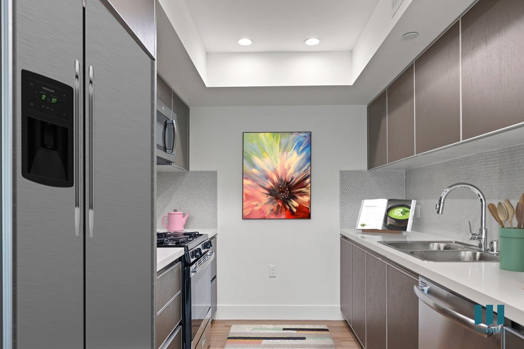 Modern Kitchen with Stainless-Steel Refrigerator, Stve, Microwave Oven, and Dishwasher
