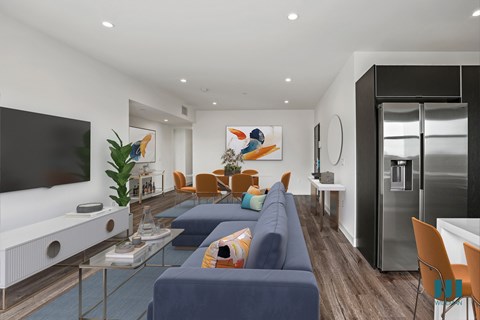 A modern living room with a blue couch and a television.