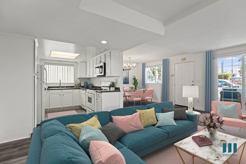 a living room with a blue couch and a kitchen