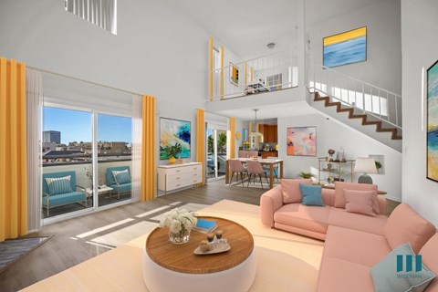 A living room with a pink couch and a wooden coffee table.