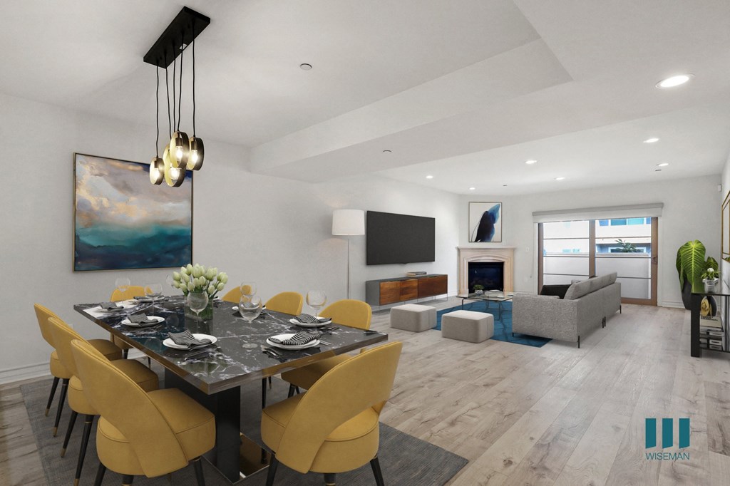 Open-Concept Dining and Living Room Area with Fireplace and Patio