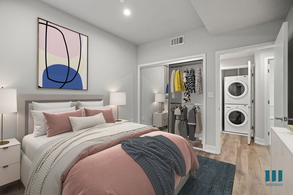 Bedroom with Mirrored Closet and In-Suite Washer & Dryer in Hallway