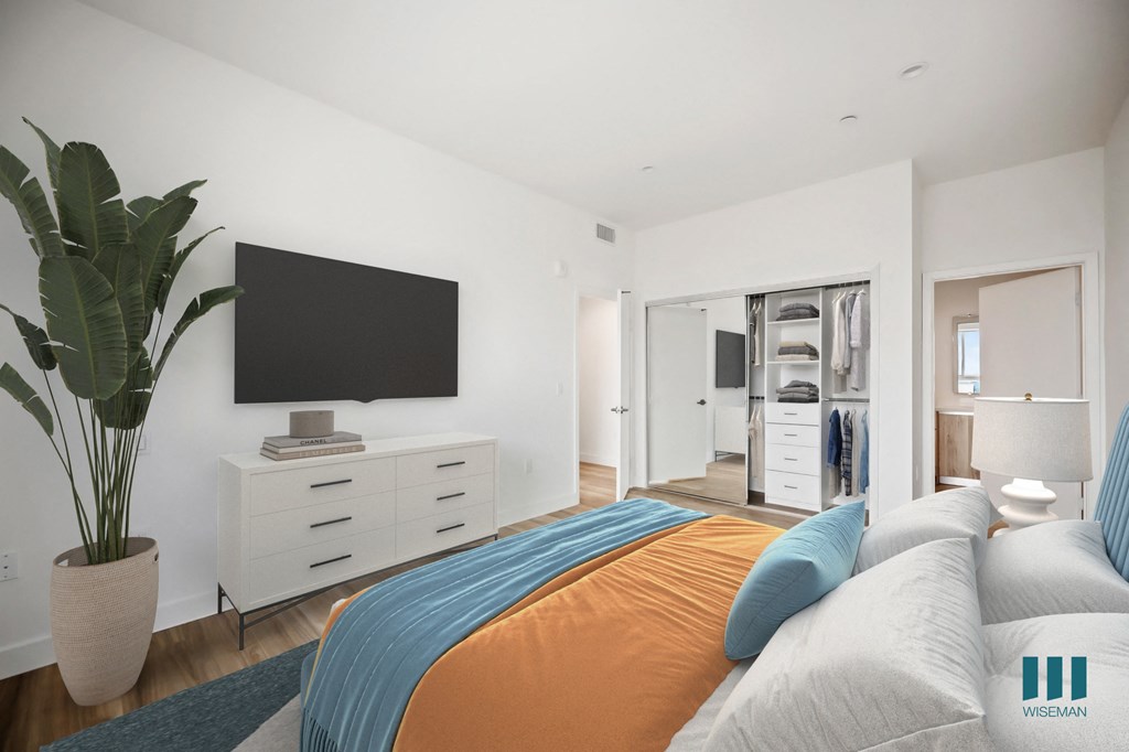 a bedroom with a large bed and a tv