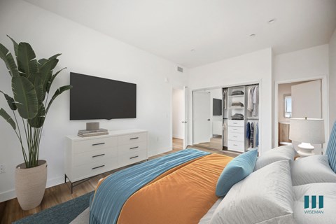 a bedroom with a large bed and a tv