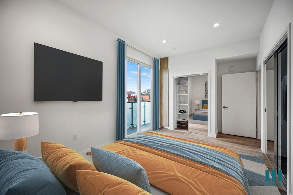 a bedroom with a large bed and a tv