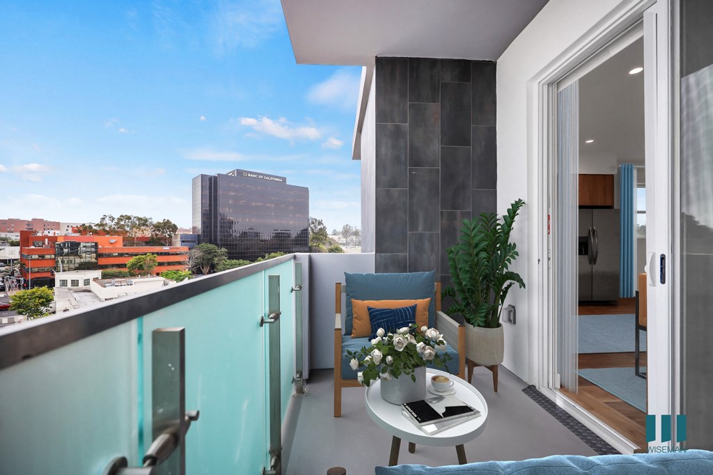 a room with a balcony and a view of the city