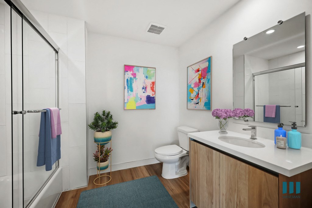 a bathroom with a sink and a toilet and a shower