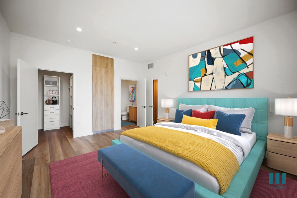 a bedroom with a bed and a blue couch