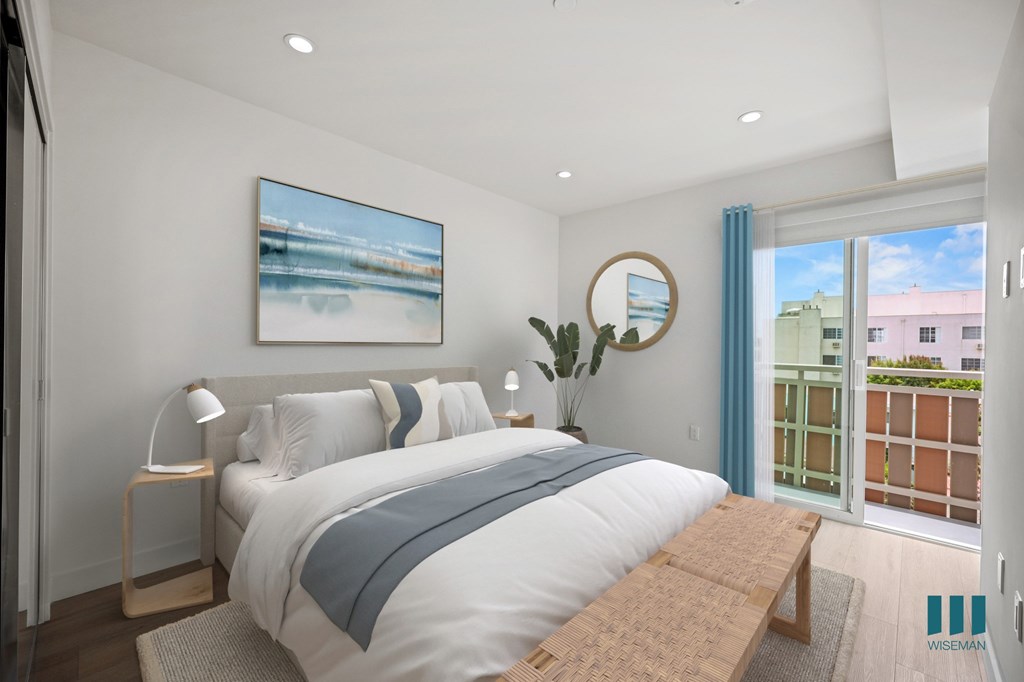 A bedroom with a large bed and a painting on the wall.